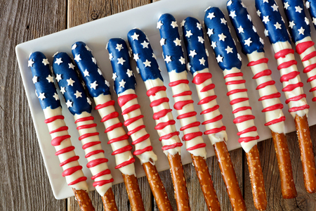 Group of Fourth of July American flag themed pretzel rods on a white plateの写真素材