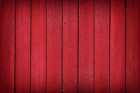 Rustic old weathered red wood plank background with vignetteの写真素材