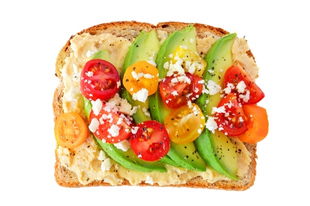 Avocado toast with hummus and tomatoes isolated on a white backgroundの写真素材