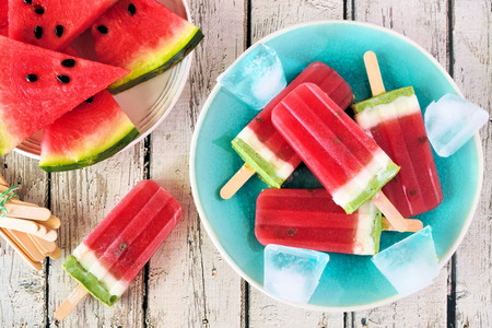 Homemade summer watermelon ice pops, top view over rustic white woodの写真素材