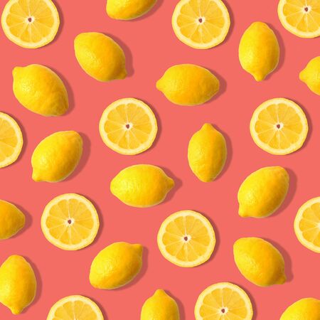 Summer fruit pattern of lemons and lemon slices on a living coral colorの写真素材
