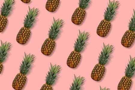 Pineapple fruit pattern on a pastel pink backgroundの写真素材