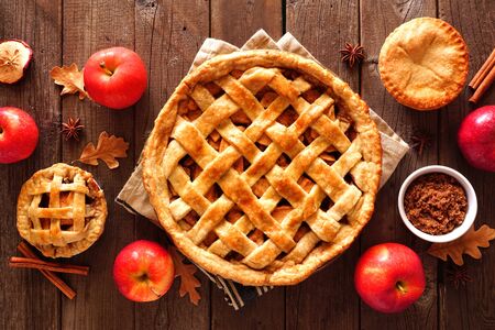 Homemade autumn apple pies, overhead view table scene with a rustic wood backgroundの写真素材