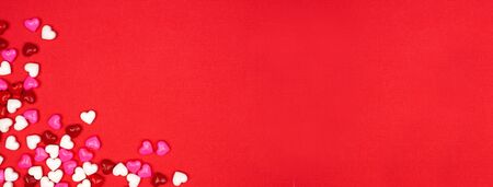 Valentines Day banner with candy hearts corner border over a redの写真素材