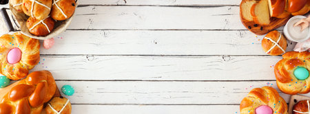 Easter selection of fresh breads, top view double side border with a white wood background