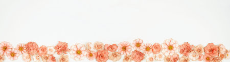 Mothers Day or spring bottom border of pink paper flowers over a white