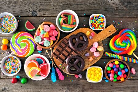 Colorful sweet candy buffet table scene, above view over rustic woodの写真素材