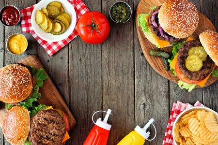 BBQ hamburger frame, above view over a dark wood backgroundの写真素材