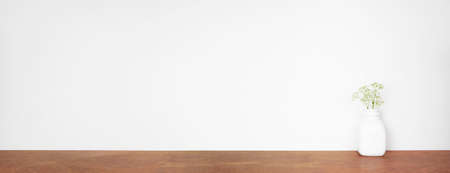 Mock up square wood frame with home decor, plants and branches. Wooden shelf against a white wall. Copy space.の写真素材