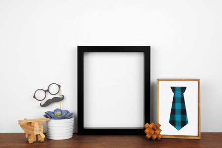 Mock up black frame with rustic Fathers Day theme decor.
