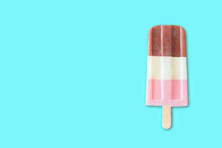 Single neapolitan striped ice cream against a bright blue background with copy space. Minimal summer concept.の写真素材