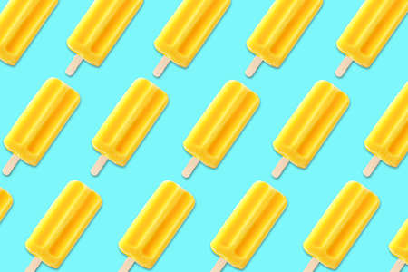 Colorful summer pattern. Bold yellow  ice creams on a bright blue background. Top view.の写真素材