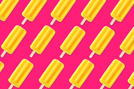 Colorful summer pattern. Bright yellow ice pops on a bold pink background. Top view.の写真素材