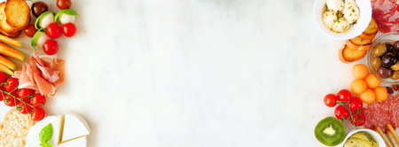 Italian theme charcuterie double border against a white marble banner background. Variety of cheese, meat and fruit appetizers. Top view with copy space.の写真素材