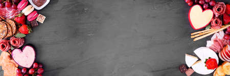 Valentine's Day theme charcuterie double border. Above view over a dark slate banner background. Copy space.の写真素材