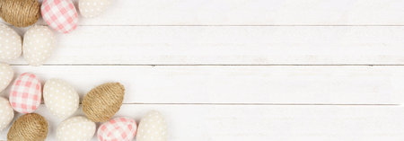 Easter Egg corner border of modern farmhouse style eggs. Top view over a white wood banner...