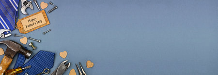 Happy Fathers Day gift tag with corner border of ties and tools on a blue grey paper banner...