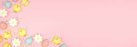 Easter candy corner border. Colorful pastel candy eggs, chicks and flowers. Above view side border...