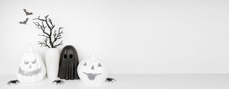 Halloween shelf decor with copy space against a white wall banner background. White shelf with jack...