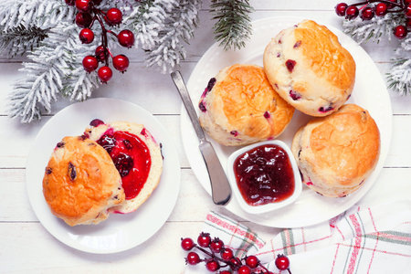 Fresh Cranberry scones with jam. Top view table scene on a white wood background. Christmas theme.の写真素材