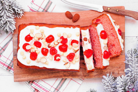Christmas cherry loaf. Overhead view table scene on a white wood background.の写真素材