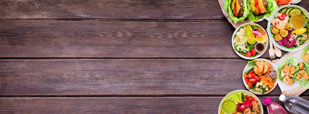 Healthy take out fast food side border. Top down view over a dark wood banner background. Table...