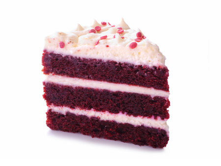 Red velvet cake slice isolated on a white background. Three tier cake with cream cheese frosting.の写真素材