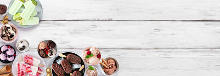 Cool summer food corner border. Assortment of ice cream bowls, popsicles and frozen treats. Overhead view on a white wood banner background. Copy space.の写真素材