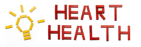 Invest in your health, heart health in red wooden blocks on a white background. Flat lay.
