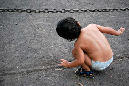 little boy going under a chainの写真素材