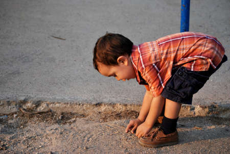 Cute boy bending over, curiosityの写真素材