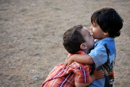 Two little boys embracingの写真素材