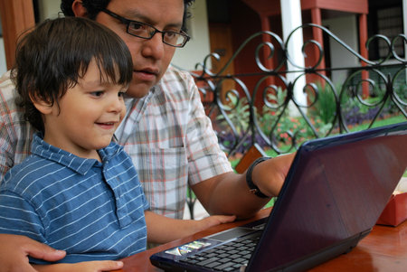 Father and son on the computer together