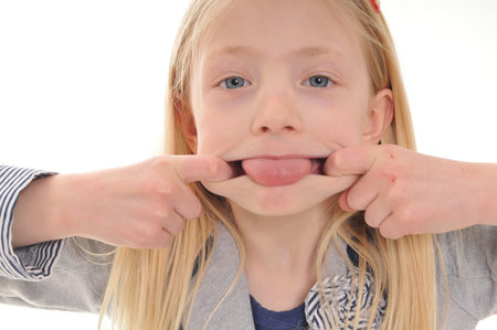 pretty blonde girl pulling a face  isolated on white background