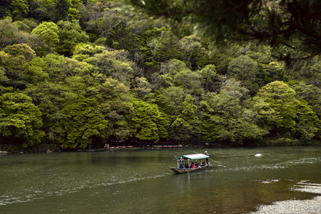 Tourists cruising down the Hozu River in Arashiyama, Japan