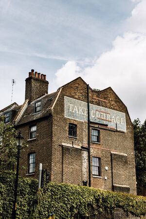 "Take Courage" building on Red Cross Way in Southwark, London, on a warm, summer day.のeditorial素材