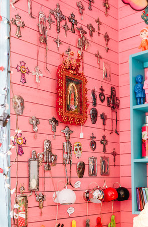 A pink wall display of religious decor at a store, Coctail, in Gamla Brogatan.  Stockholm, Sweden