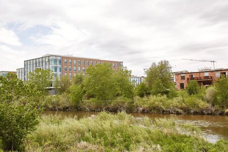 Condos and highrise buildings near Platte River at Confluence Park in the Riverfront Park neighborhood of Denver, Coloradoの写真素材