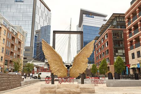 Millennium Bridge and wing statue at the Riverfront Park neighborhood of Denver, Colorado.  Commons Parkのeditorial素材