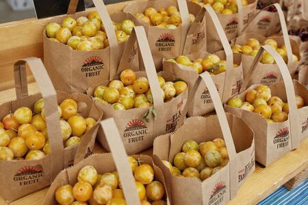 Boulder, Colorado - August 10th, 2019: Brown bags of organic local yellow cherries for sale at a Farmers Market in Boulder.のeditorial素材