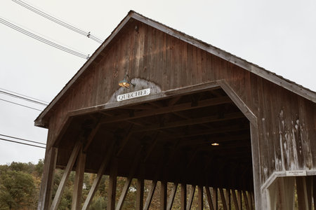 Quechee Covered Bridge overlooking Ottauquechee River Falls in the New England town of Quechee,...