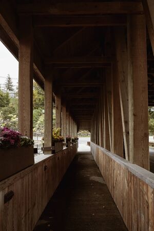 Quechee Covered Bridge overlooking Ottauquechee River Falls in the New England town of Quechee, Vermontの写真素材