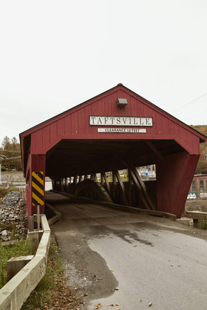 Historic Taftsville Covered Bridge surrounded by Fall foliage in Woodstock, Vermont