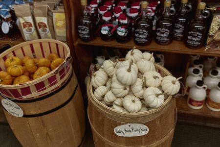 Woodstock, Vermont - September 30th, 2019: Variety of New England maple syrup and small pumpkins for sale at a general store in Woodstock.のeditorial素材