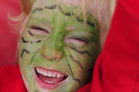child is excited for face paint at the school fairの写真素材
