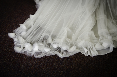 textured sheer wedding dress train with fabric flower buds closeupの写真素材