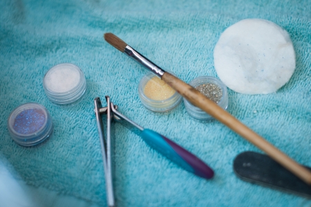 blue towel with beauty accessories and tools scattered over itの写真素材