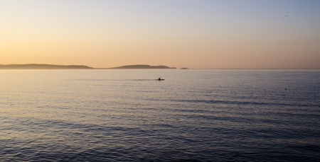 Sea view with canoeist and Island Magee in the background, taken from Bangor Bay, Northern Irelandの写真素材