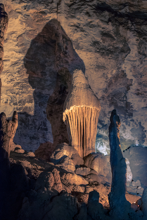 An illuminated stalagmite formation resembling a mushroom at the Wondercave in South Africa, near Johannesburgの写真素材