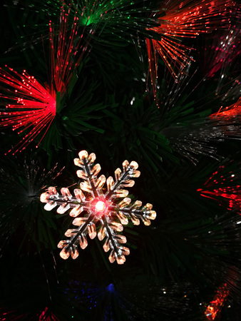 Christmas star and green, red light on a dark backgroundの写真素材